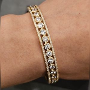 Cubic Zirconia set in 14k gold plated sterling silver bangle. 7" circumference.